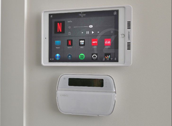 A smart home device mounted on the wall, featuring a sleek design and digital display for home automation control.