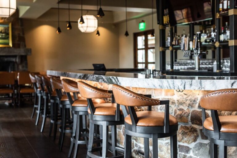 A commercial bar with leather seats and modern AV installations.