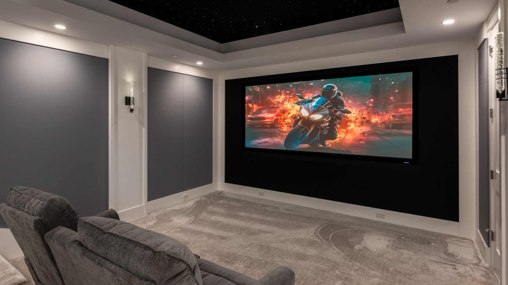 A professional home theater installation with inset lighting and comfortable furniture.